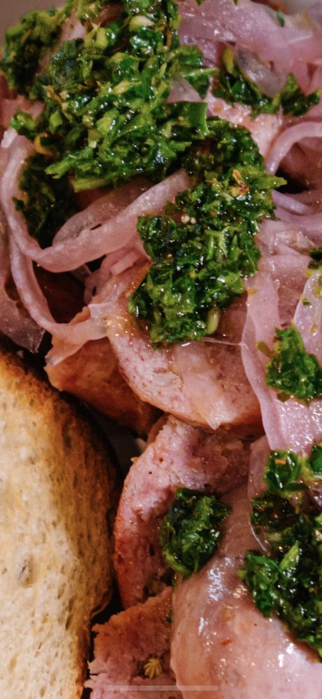 Chorizada platter with chimichurri and pickled onions