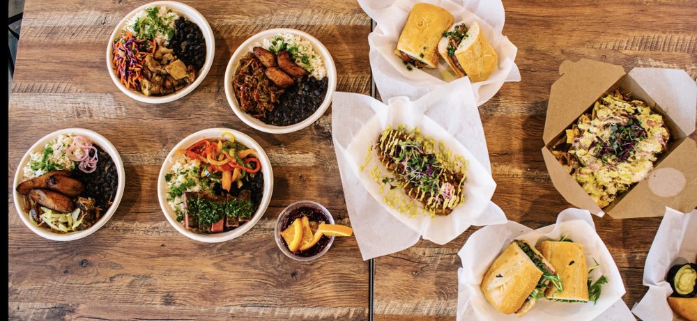 The full Mojo Grill spread of bowls, sandwiches, empanadas and Cuban nachos