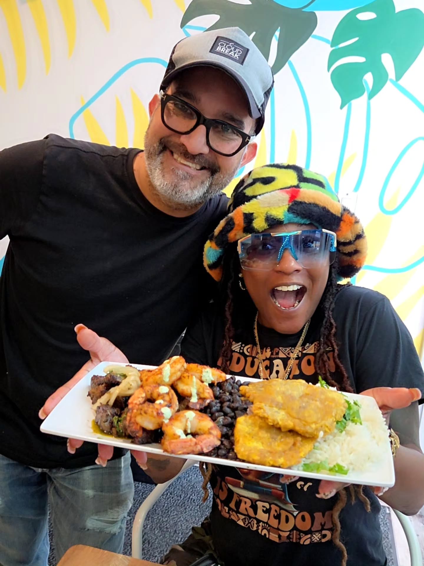 Luis serving a happy customer at Mojo Grill